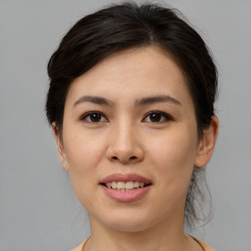 Joyful asian young-adult female with medium  brown hair and brown eyes