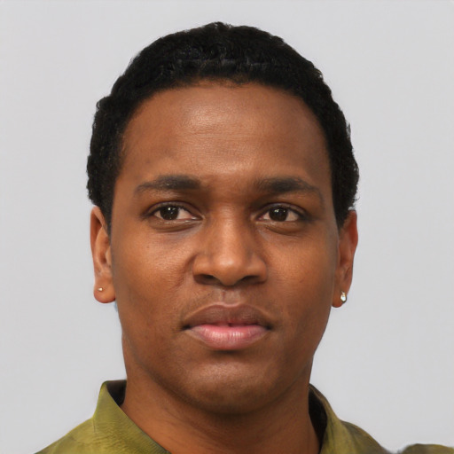 Joyful black young-adult male with short  black hair and brown eyes