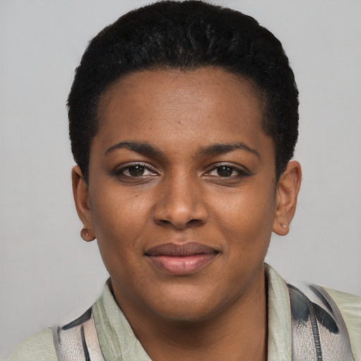 Joyful black young-adult female with short  black hair and brown eyes