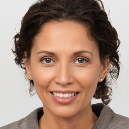 Joyful white adult female with medium  brown hair and brown eyes