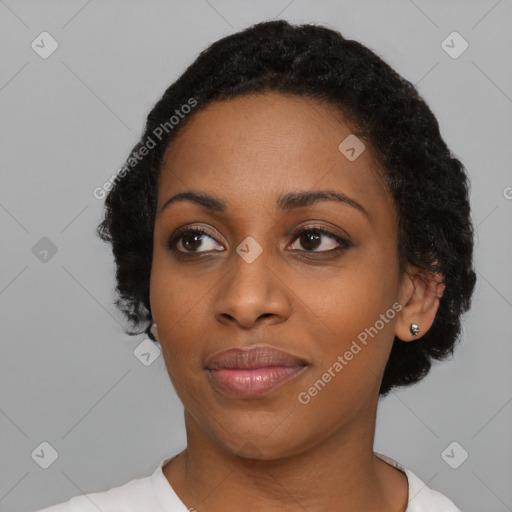 Joyful black young-adult female with short  black hair and brown eyes