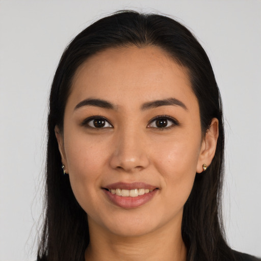 Joyful latino young-adult female with long  black hair and brown eyes