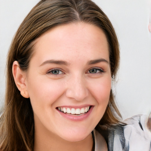 Joyful white young-adult female with long  brown hair and blue eyes