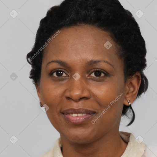 Joyful black adult female with short  brown hair and brown eyes