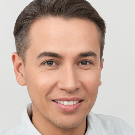 Joyful white young-adult male with short  brown hair and brown eyes