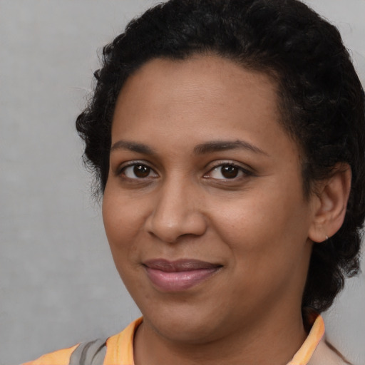 Joyful latino young-adult female with short  brown hair and brown eyes