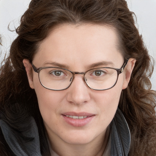 Joyful white adult female with long  brown hair and blue eyes