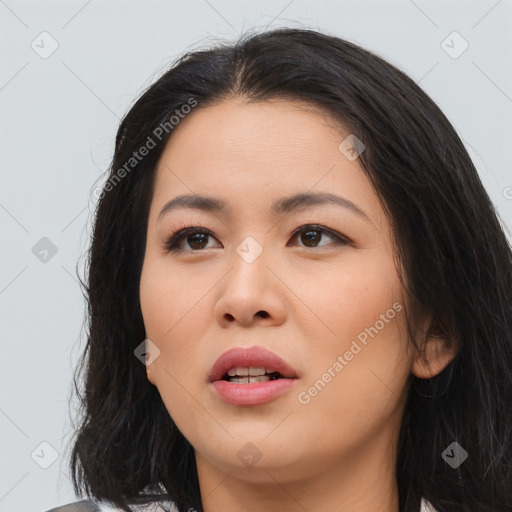 Joyful asian young-adult female with long  brown hair and brown eyes