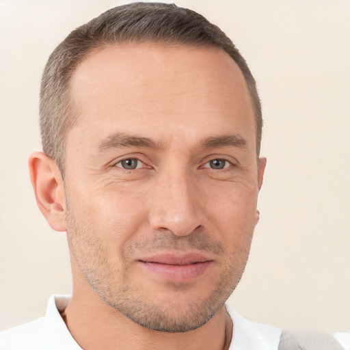 Joyful white adult male with short  brown hair and brown eyes