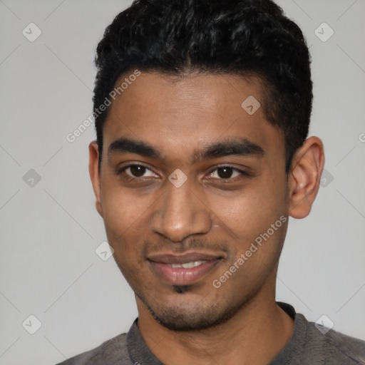 Joyful black young-adult male with short  black hair and brown eyes