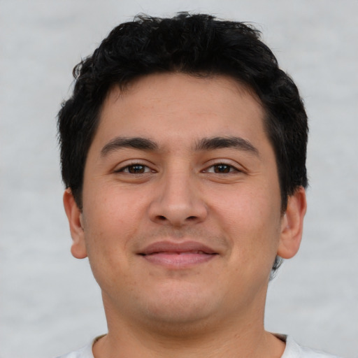 Joyful latino young-adult male with short  brown hair and brown eyes