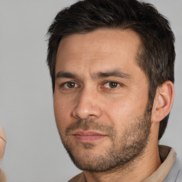 Joyful white adult male with short  brown hair and brown eyes