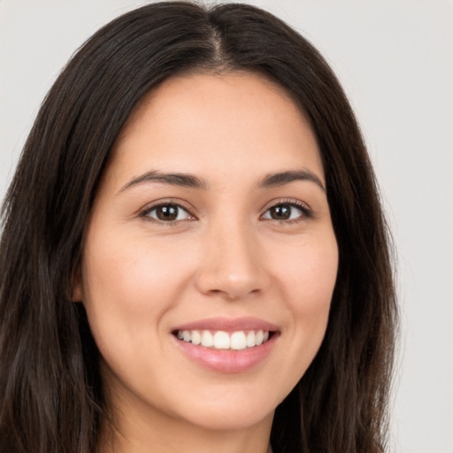 Joyful white young-adult female with long  brown hair and brown eyes