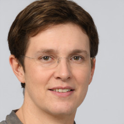 Joyful white adult male with short  brown hair and grey eyes