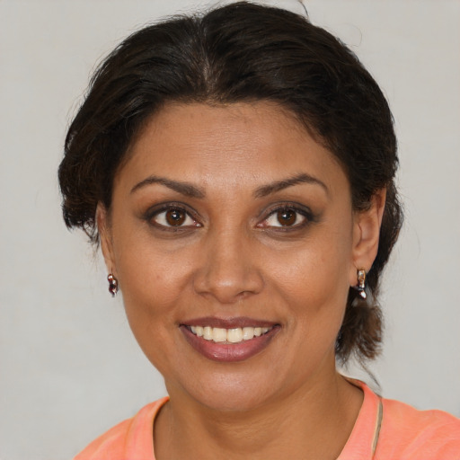 Joyful white adult female with medium  brown hair and brown eyes