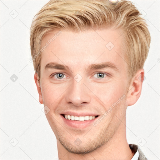 Joyful white young-adult male with short  brown hair and grey eyes