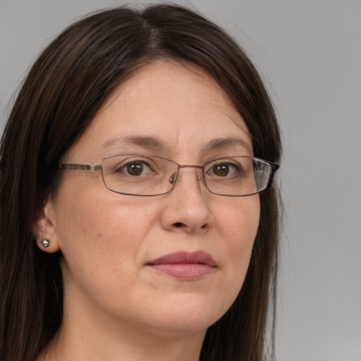 Joyful white adult female with long  brown hair and brown eyes