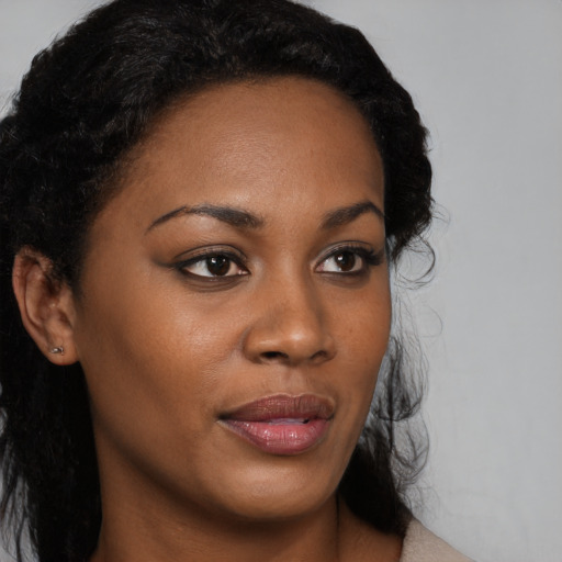 Joyful black young-adult female with medium  black hair and brown eyes