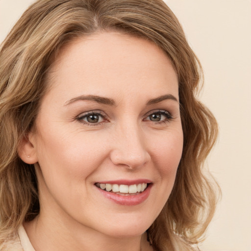 Joyful white young-adult female with medium  brown hair and green eyes