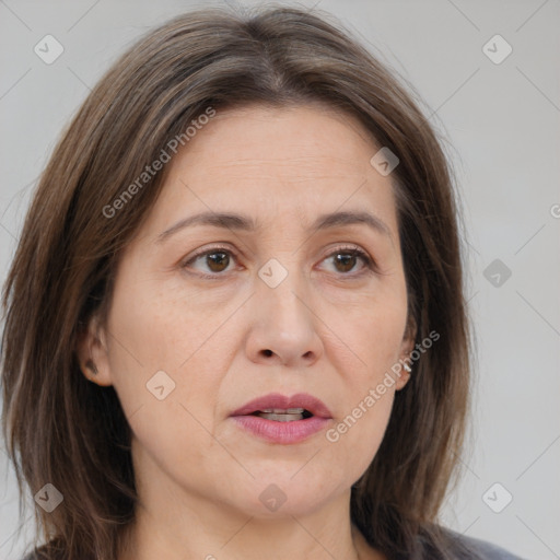 Joyful white adult female with medium  brown hair and brown eyes