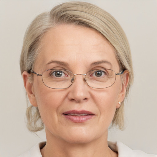 Joyful white middle-aged female with medium  blond hair and blue eyes