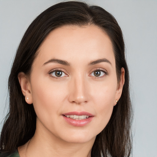 Joyful white young-adult female with long  brown hair and brown eyes