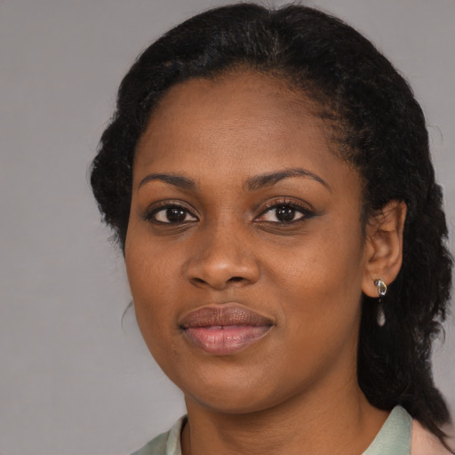 Joyful black young-adult female with medium  black hair and brown eyes