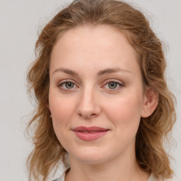 Joyful white young-adult female with medium  brown hair and blue eyes