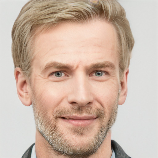 Joyful white adult male with short  brown hair and grey eyes