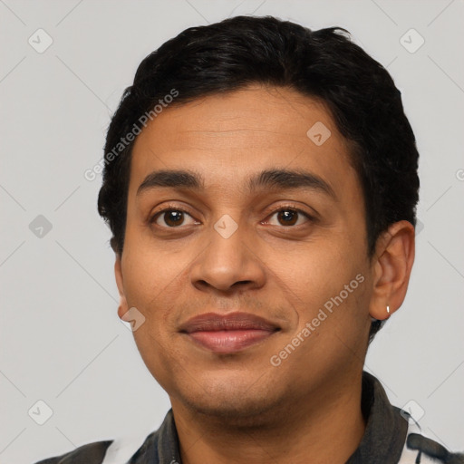 Joyful latino young-adult male with short  black hair and brown eyes