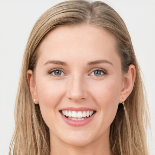 Joyful white young-adult female with long  brown hair and blue eyes