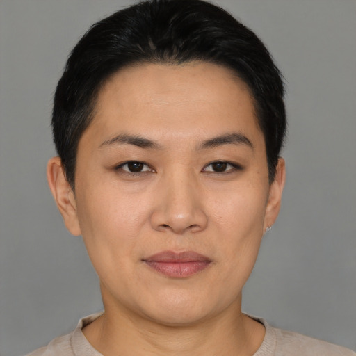 Joyful asian young-adult female with short  black hair and brown eyes