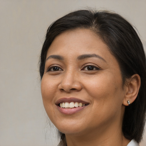 Joyful asian young-adult female with long  brown hair and brown eyes
