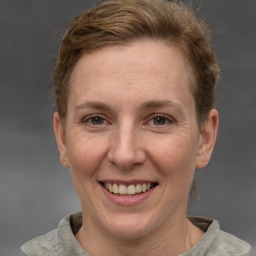 Joyful white adult female with short  brown hair and grey eyes