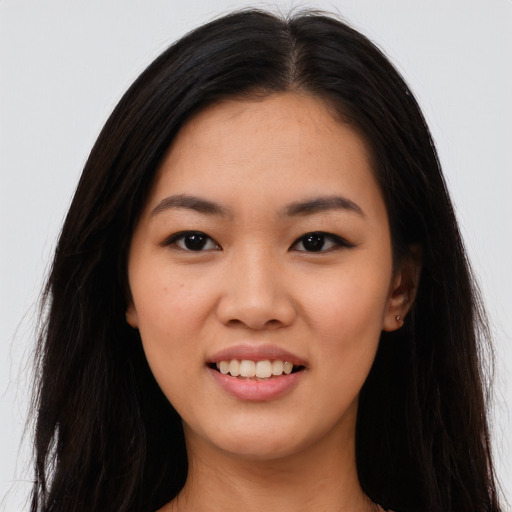 Joyful asian young-adult female with long  black hair and brown eyes