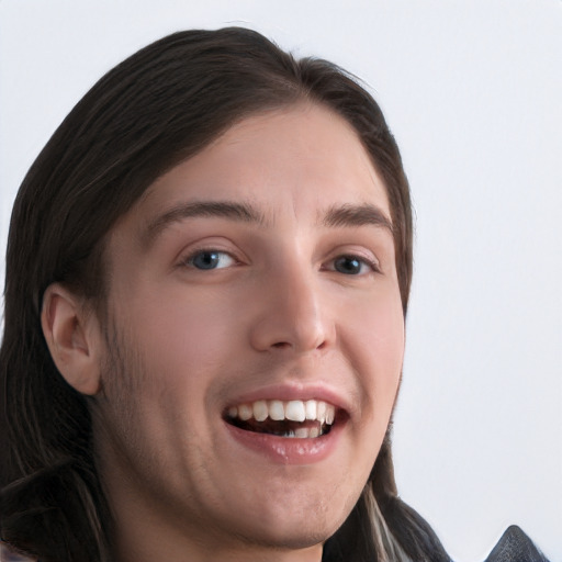 Joyful white young-adult male with long  brown hair and brown eyes