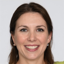 Joyful white young-adult female with long  brown hair and grey eyes