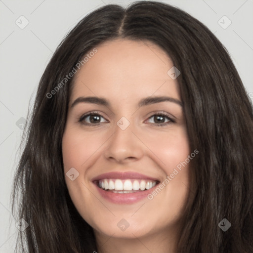 Joyful white young-adult female with long  black hair and brown eyes