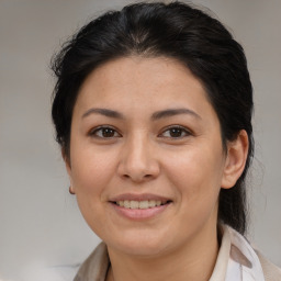 Joyful white adult female with medium  brown hair and brown eyes