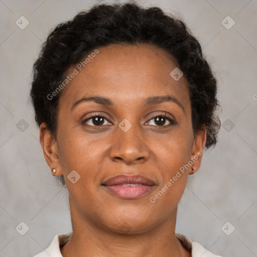 Joyful black adult female with short  brown hair and brown eyes