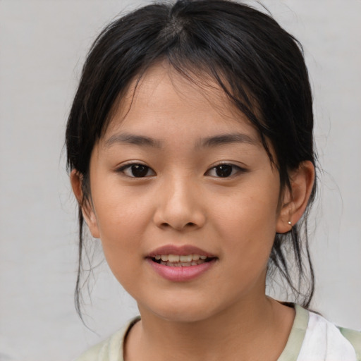 Joyful asian child female with medium  brown hair and brown eyes