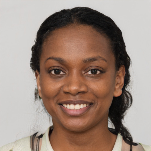 Joyful black young-adult female with medium  black hair and brown eyes