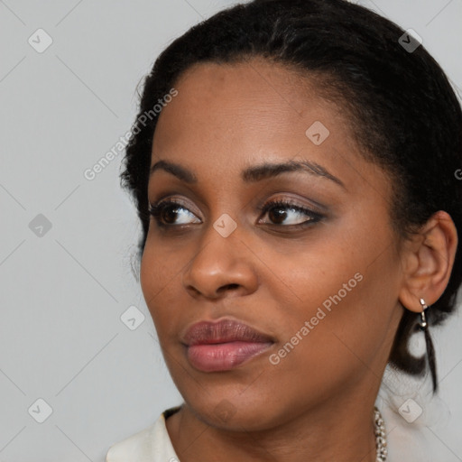 Joyful black young-adult female with medium  black hair and brown eyes