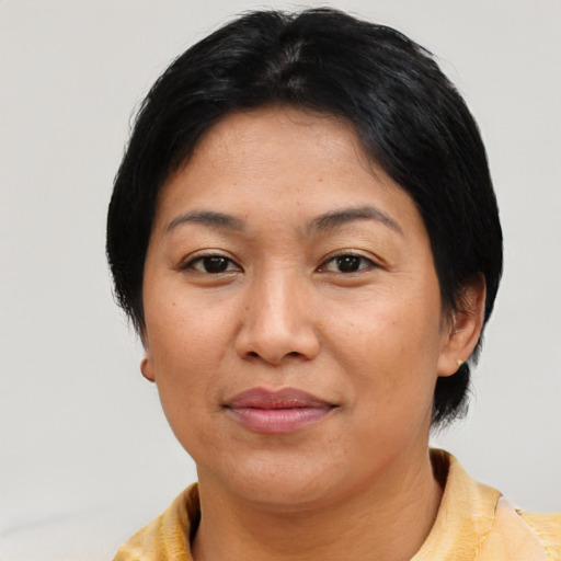 Joyful asian adult female with short  black hair and brown eyes