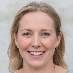 Joyful white young-adult female with medium  brown hair and blue eyes