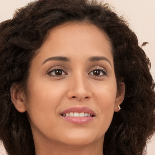 Joyful white young-adult female with long  brown hair and brown eyes