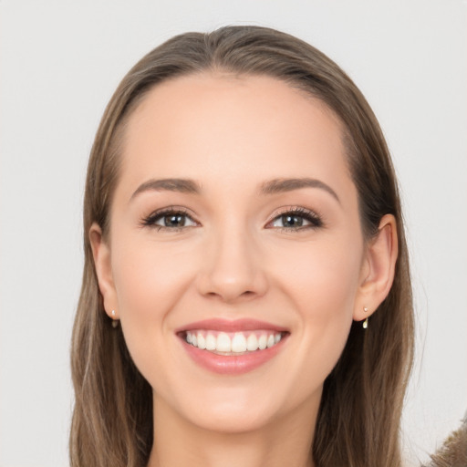 Joyful white young-adult female with long  brown hair and brown eyes