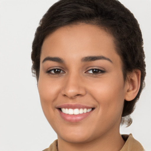 Joyful latino young-adult female with long  brown hair and brown eyes