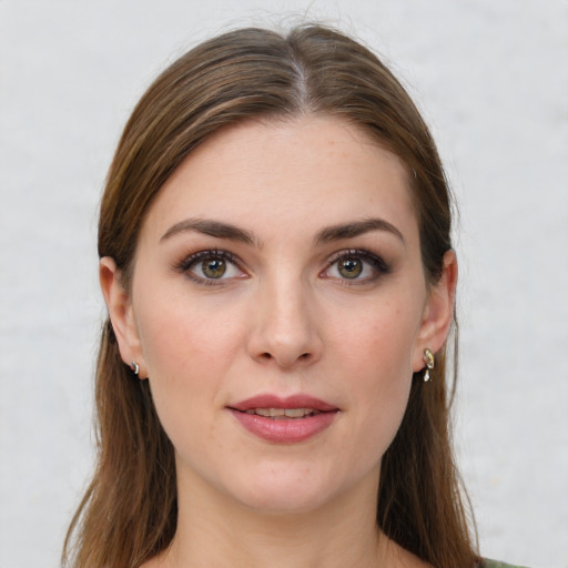 Joyful white young-adult female with long  brown hair and green eyes