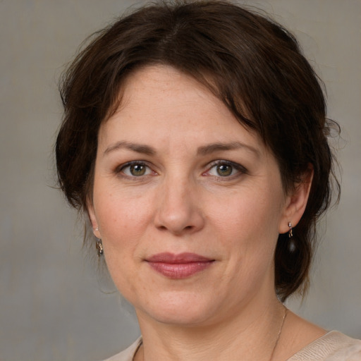 Joyful white adult female with medium  brown hair and brown eyes